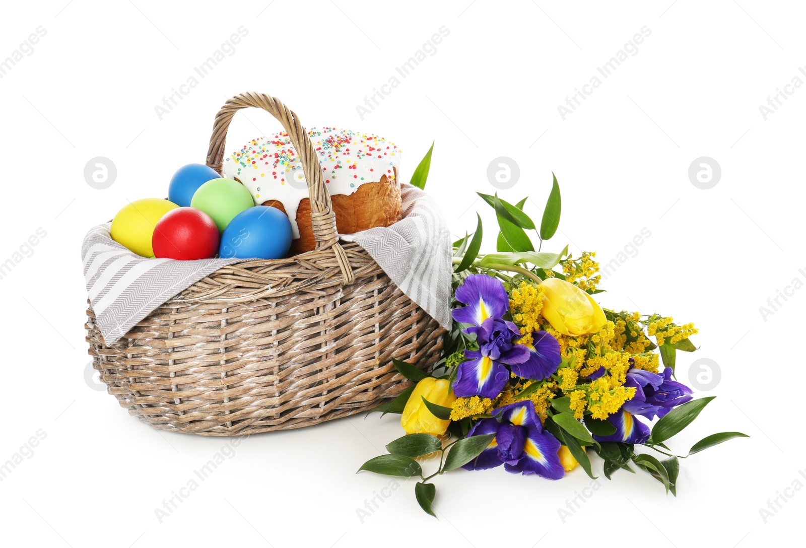 Photo of Basket with traditional Easter cake, eggs and flowers on white background