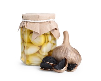 Photo of Garlic with honey in glass jar and fermented black garlic isolated on white