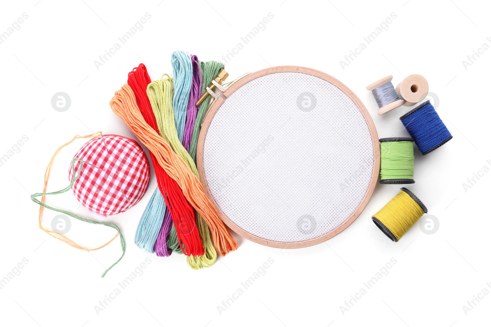 Photo of Set of embroidery equipment on white background, top view