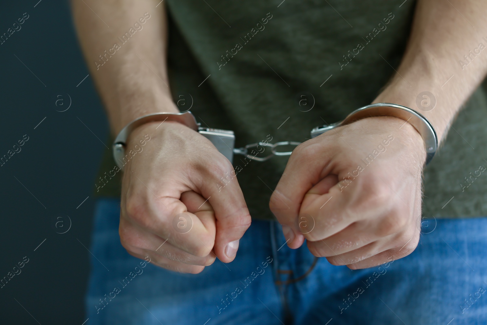 Photo of Man detained in handcuffs, closeup. Criminal law