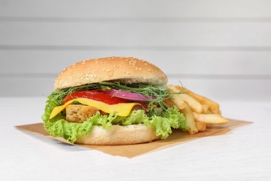 Photo of Delicious burger with tofu and fresh vegetables on white table