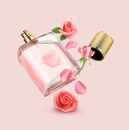Image of Bottle of perfume and roses in air on beige pink background. Flower fragrance