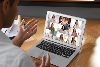 Image of Coworkers working together online. Man using video chat on laptop, closeup