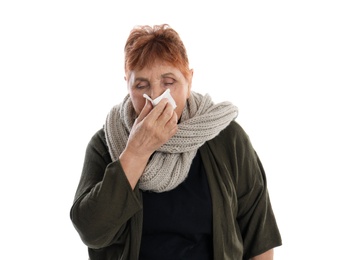 Elderly woman blowing nose on white background