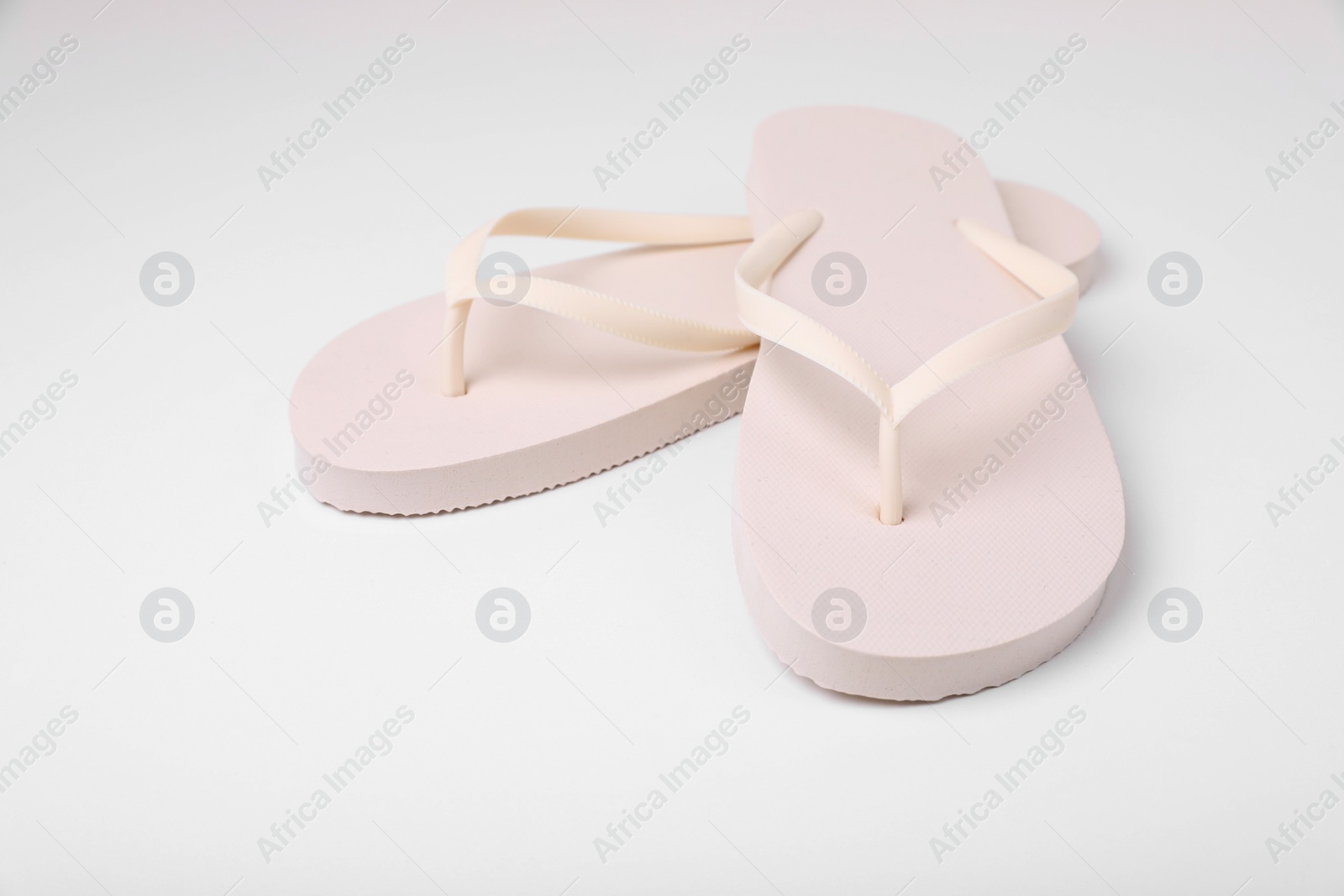 Photo of Pair of stylish flip flops on white background