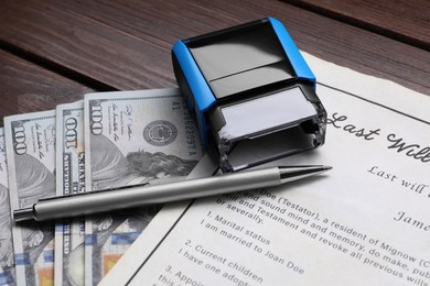 Photo of Last Will and Testament, stamp, dollar bills and pen on wooden table, closeup