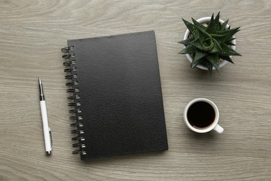 Flat lay composition with notebook on light wooden table