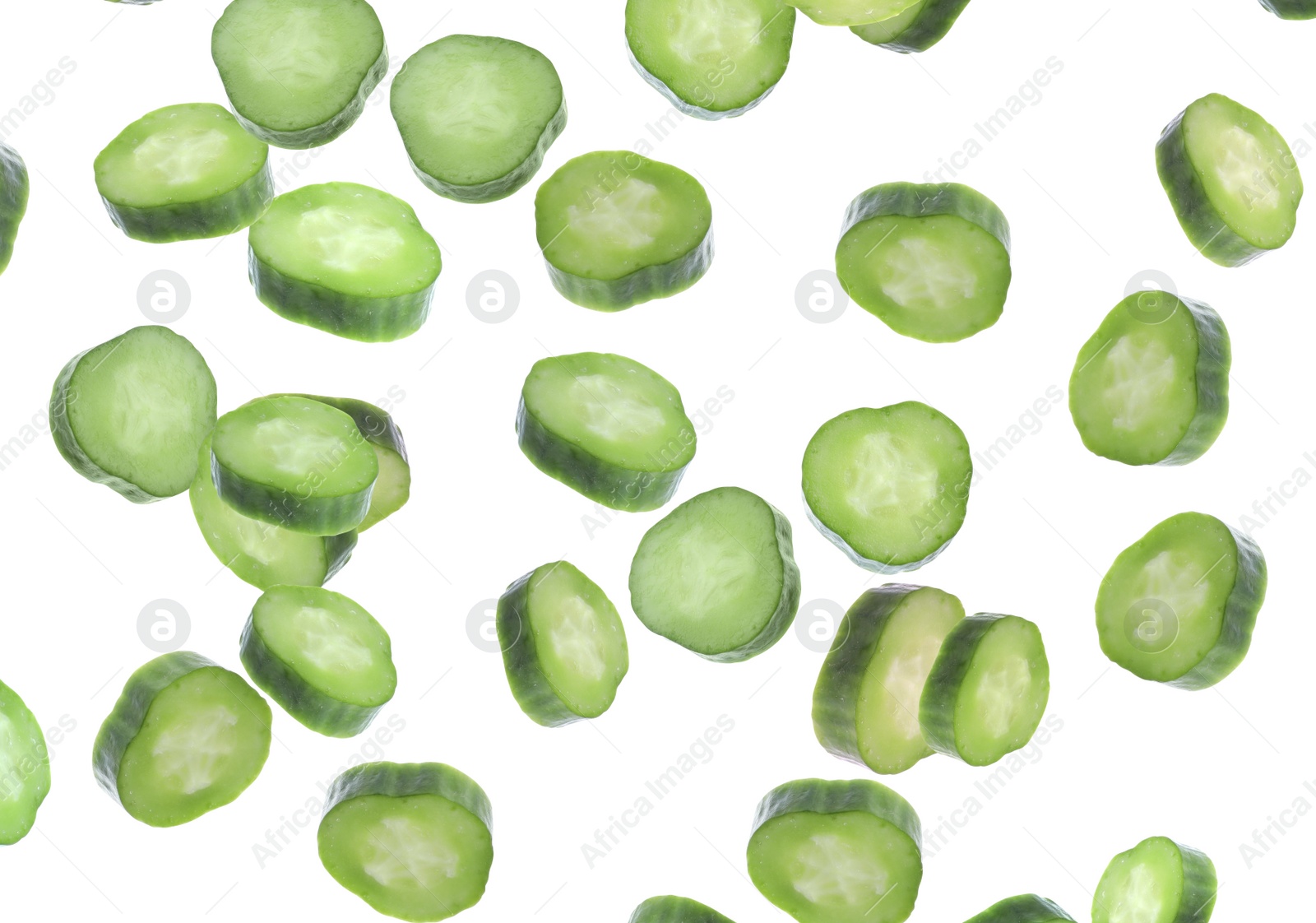 Image of Slices of fresh green cucumbers falling on white background