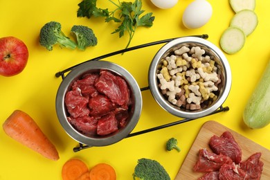 Pet food and natural ingredients on yellow background, flat lay