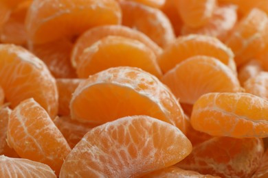 Photo of Delicious tangerine segments as background, closeup view