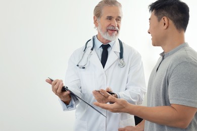 Photo of Patient having appointment with doctor on white background