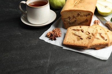Photo of Composition with tasty pear bread on black slate table. Homemade cake