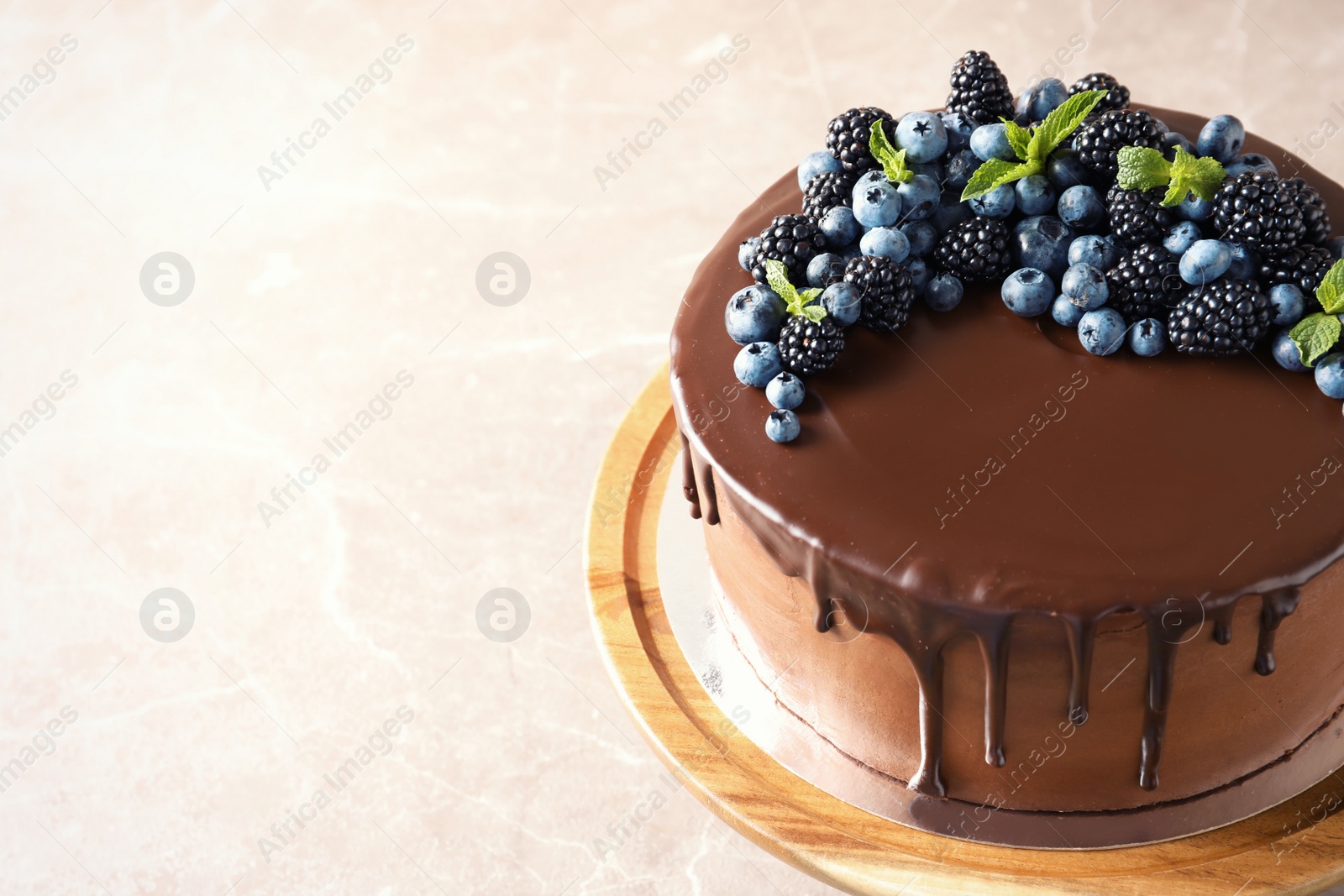 Photo of Fresh delicious homemade chocolate cake with berries on table. Space for text