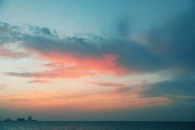Photo of Beautiful view of sea, distant city on shore and amazing sunset sky