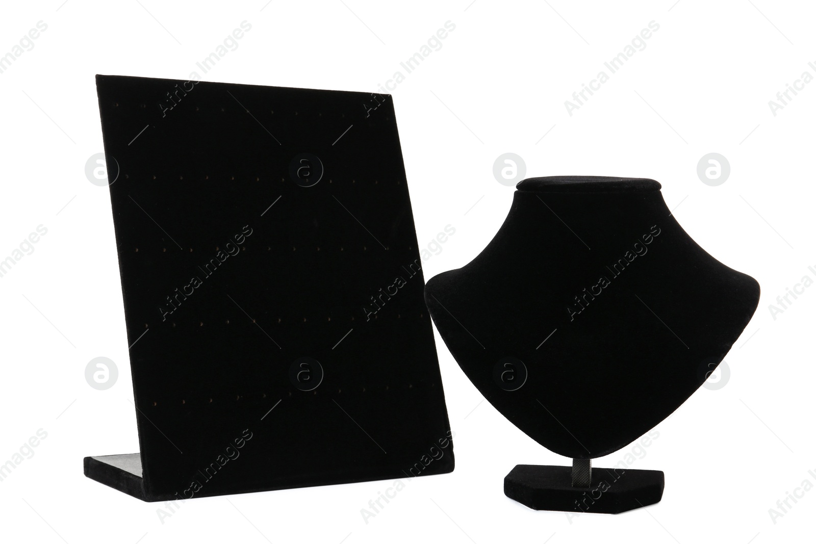 Photo of Different empty black velvet jewelry stands on white background