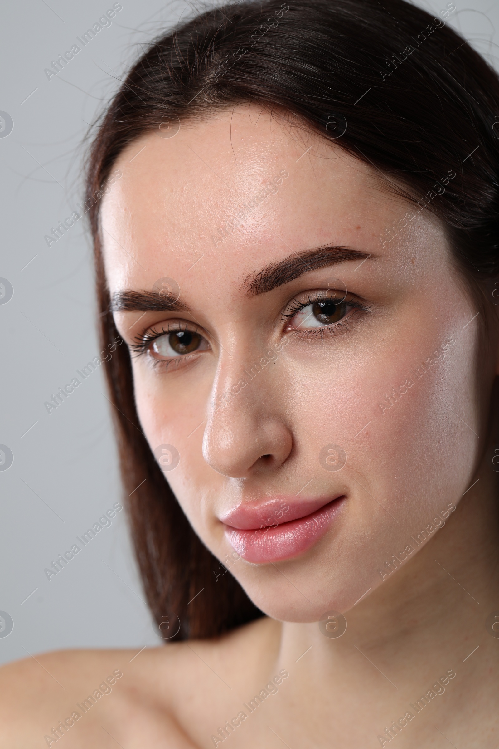 Photo of Beautiful young woman with healthy skin on light grey background