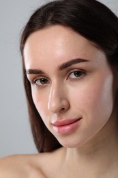 Photo of Beautiful young woman with healthy skin on light grey background