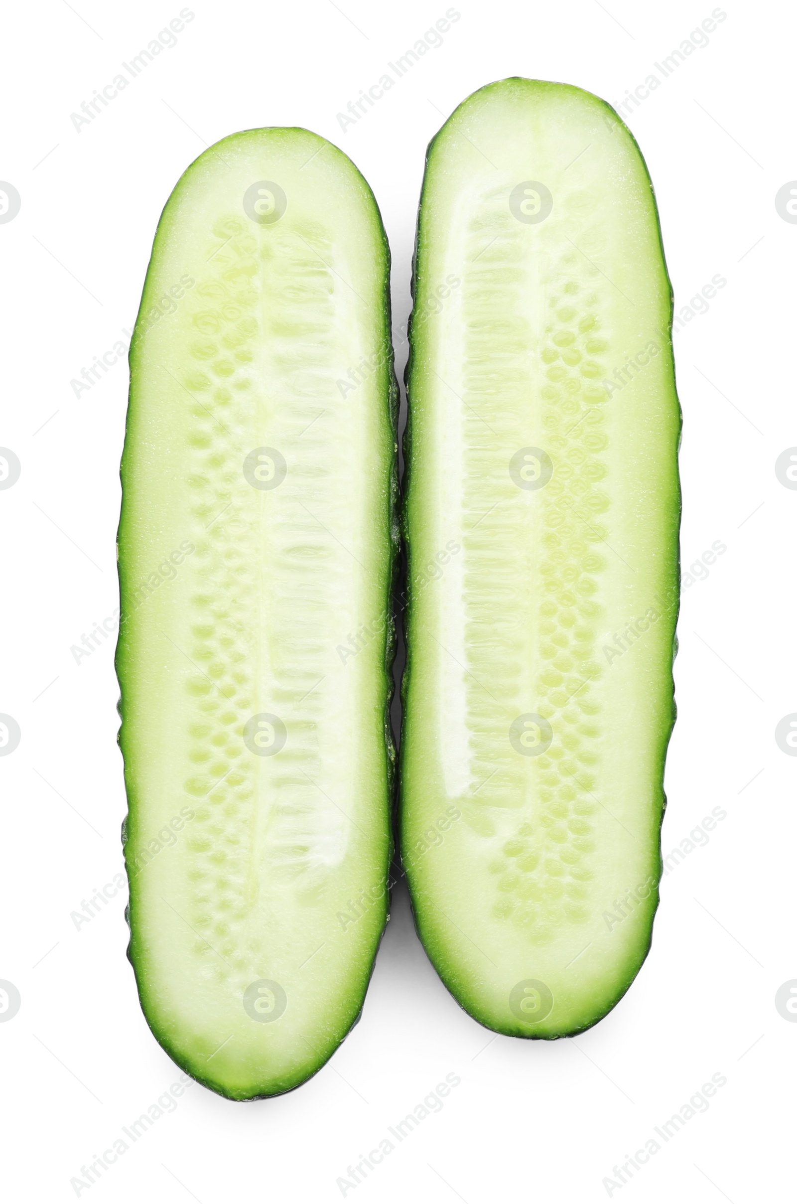 Photo of Halves of fresh ripe cucumber on white background, top view