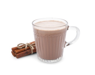 Delicious cocoa drink in glass cup and cinnamon sticks on white background