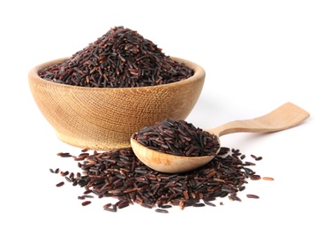 Bowl and spoon with uncooked black rice on white background