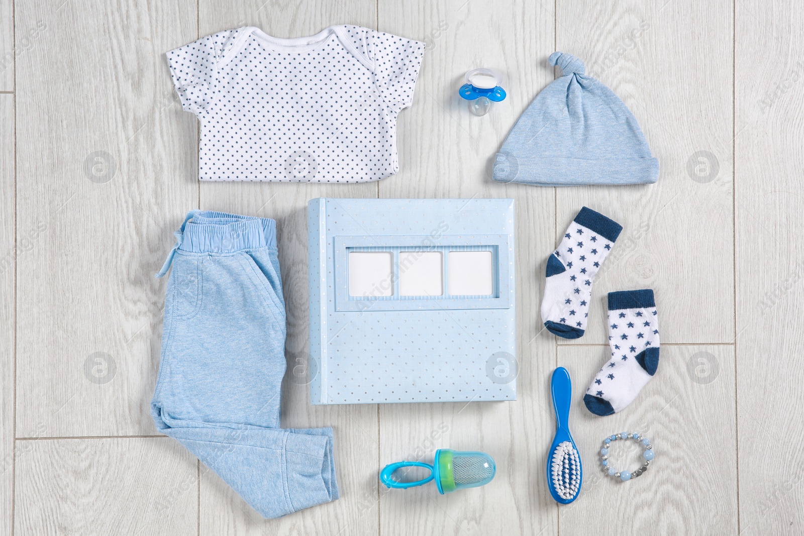 Photo of Flat lay composition with stylish child clothes and accessories on wooden background