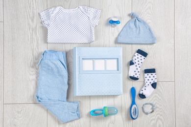 Flat lay composition with stylish child clothes and accessories on wooden background