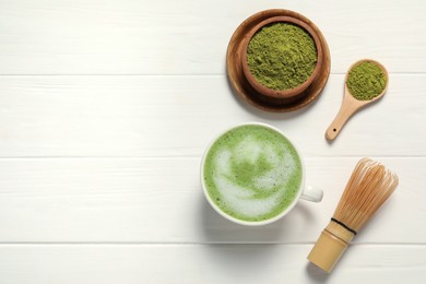 Flat lay composition with tasty matcha latte on white wooden table, space for text