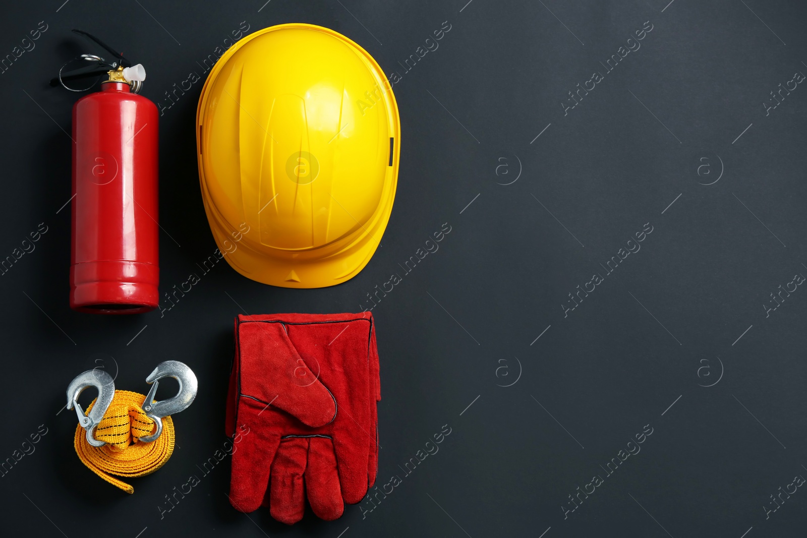 Photo of Flat lay composition with safety equipment and space for text on black background