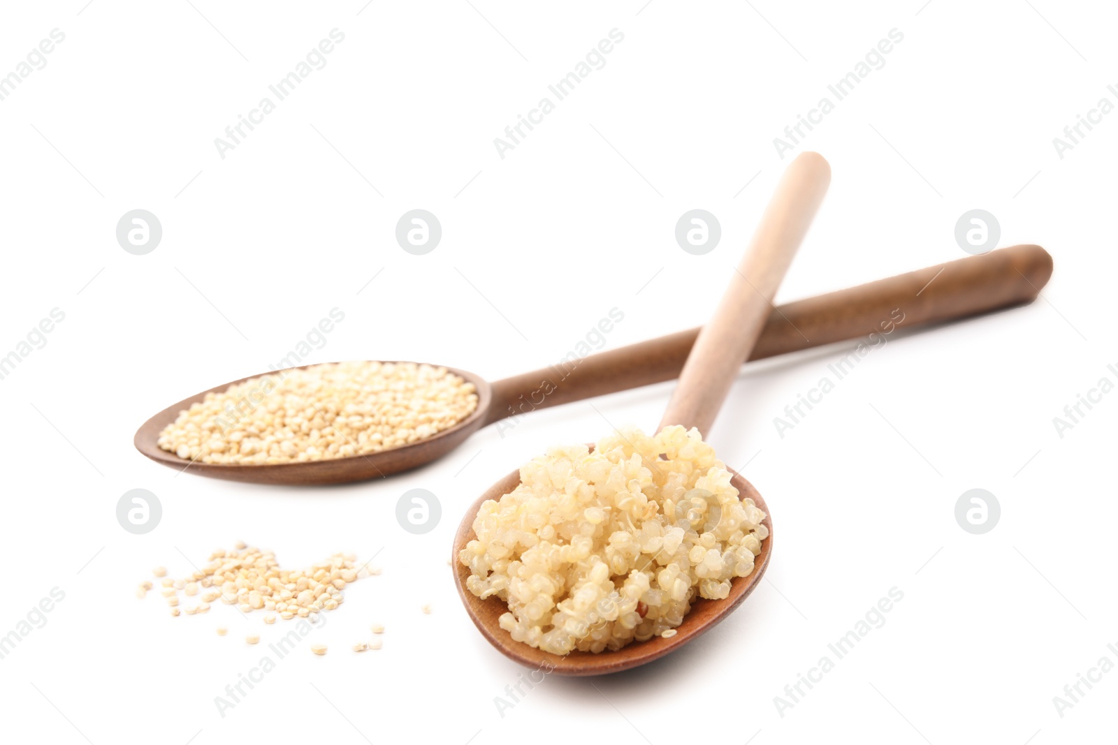 Photo of Spoons with raw and cooked quinoa isolated on white