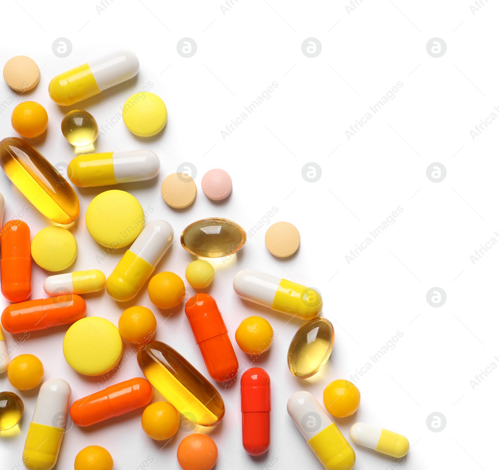 Photo of Lots of different colorful pills isolated on white, top view