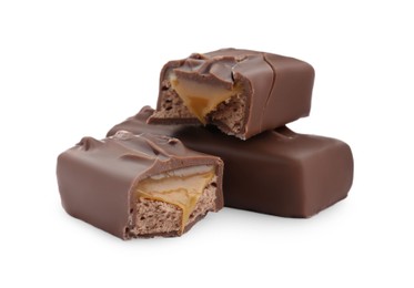 Pieces of chocolate bars with caramel on white background