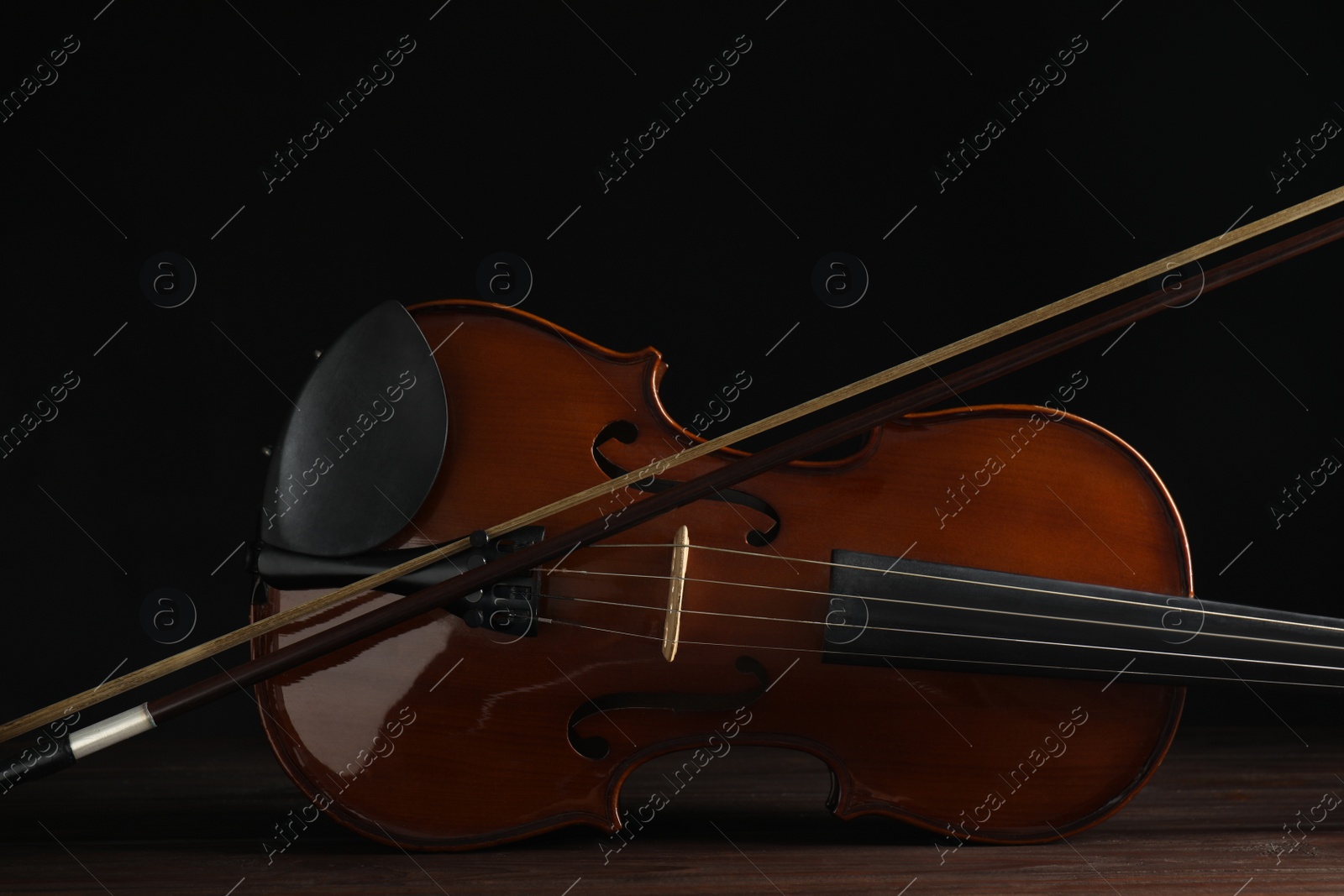 Photo of Classic violin and bow on wooden background