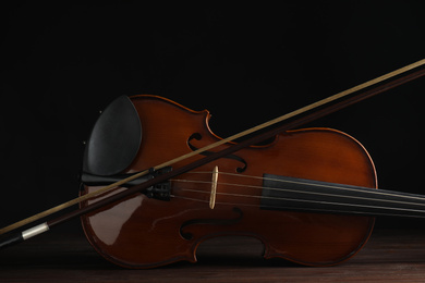 Classic violin and bow on wooden background