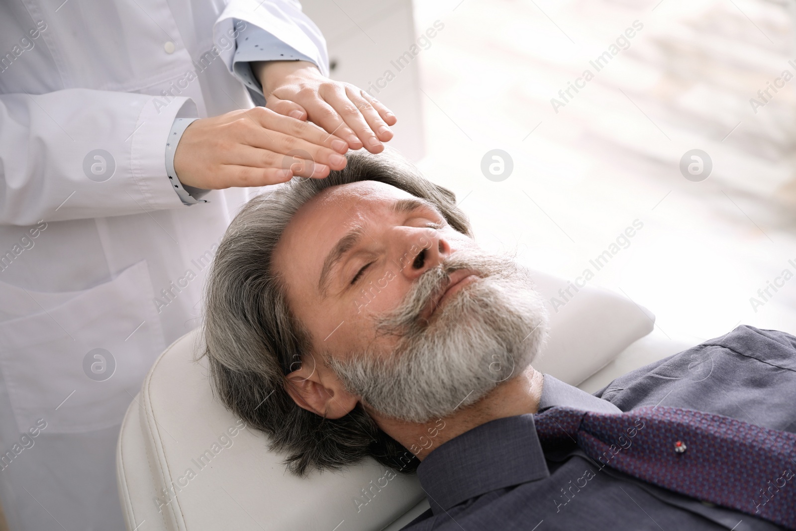 Photo of Psychotherapist and patient in office. Hypnotherapy session