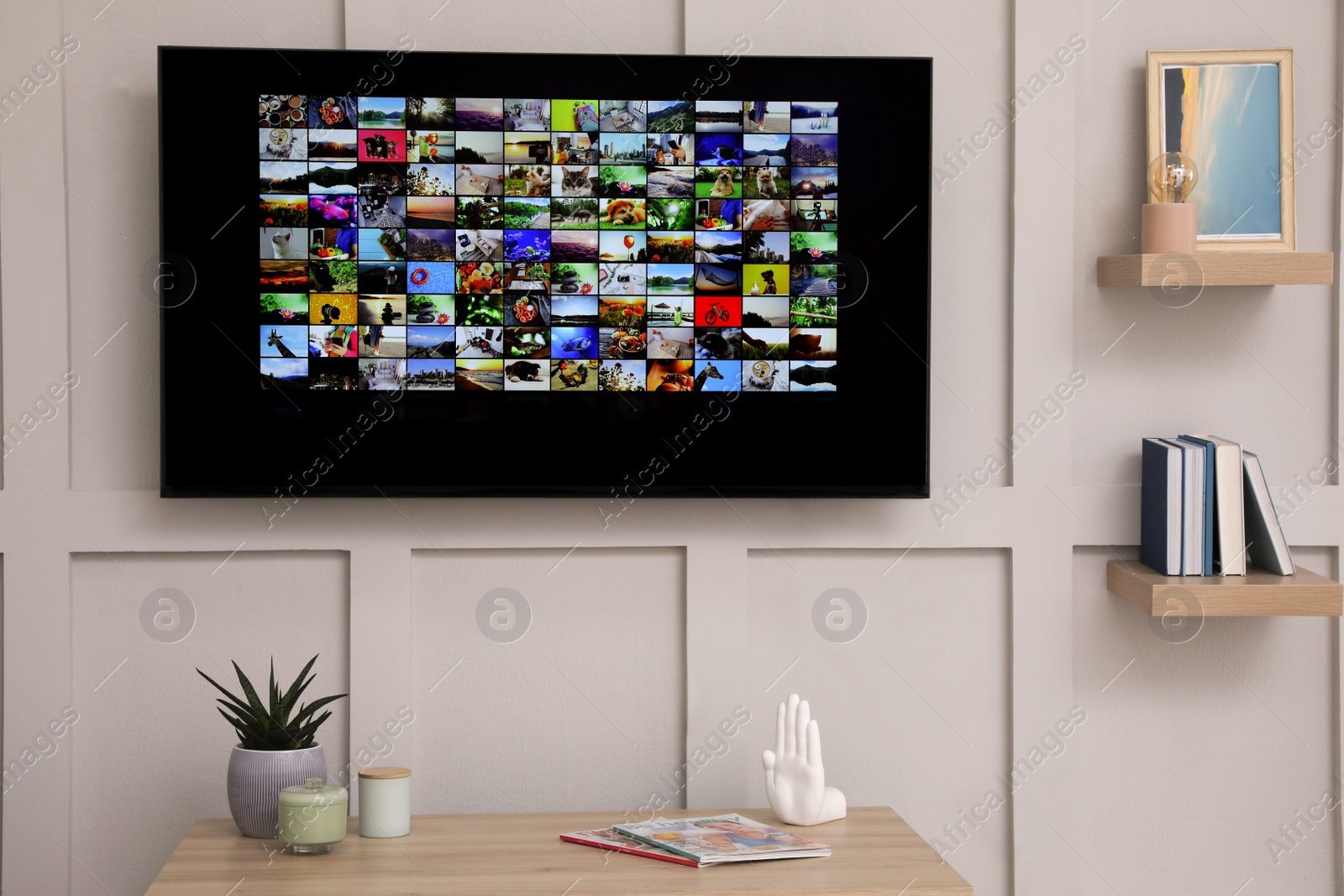 Photo of Modern TV on white wall in room