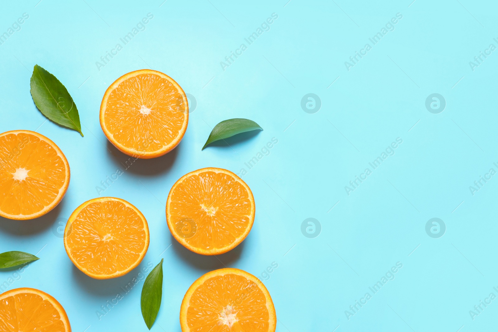 Photo of Flat lay composition with ripe oranges and space for text on color background