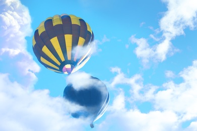 Image of Fantastic dreams. Hot air balloons in blue sky with clouds 
