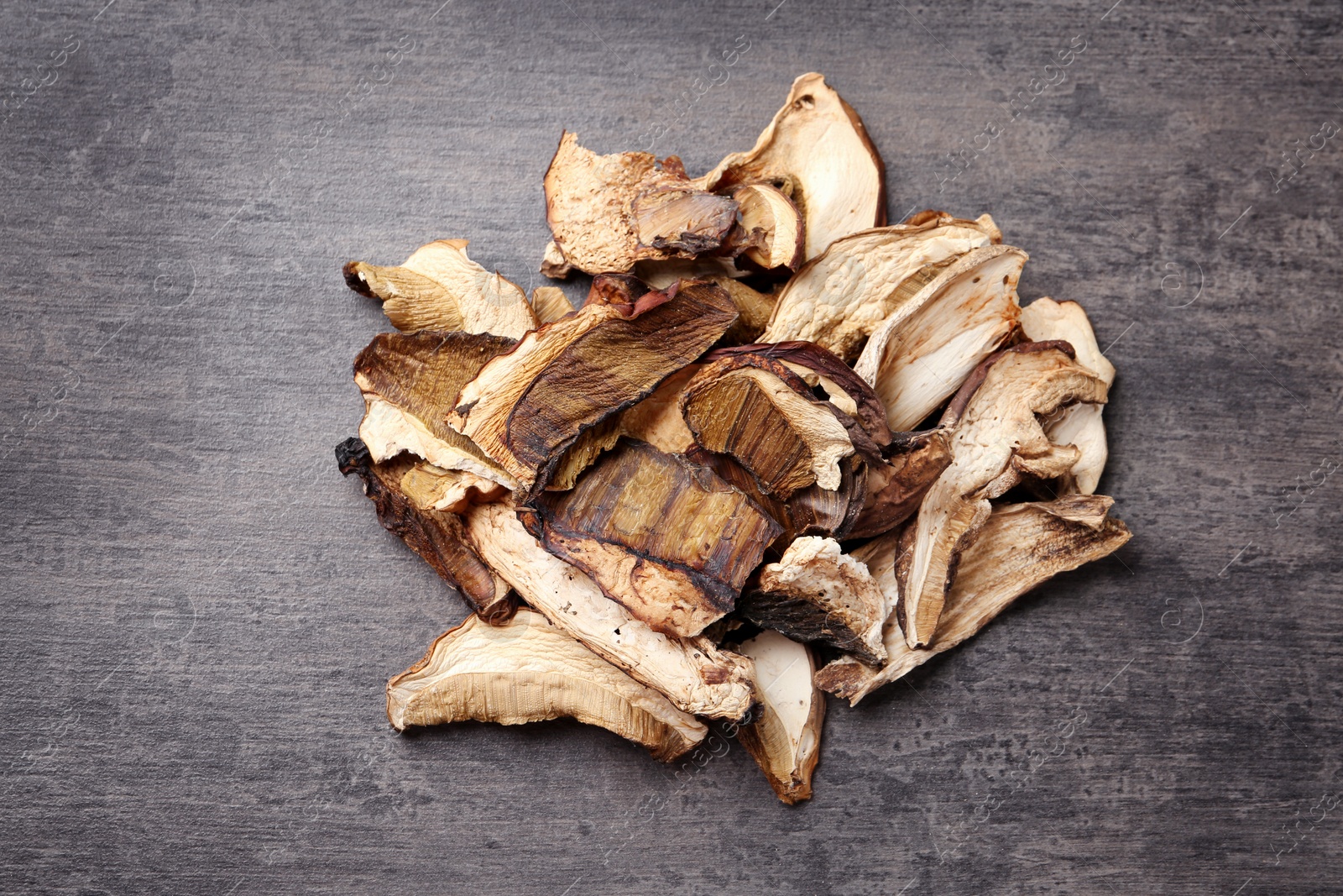 Photo of Dried mushrooms on color background, top view