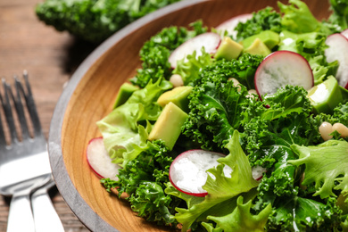 Photo of Delicious salad with kale leaves on table, closeup