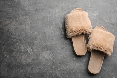 Photo of Pair of soft slippers on grey background, flat lay. Space for text