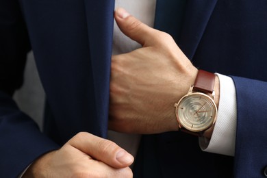 Photo of Businessman in jacket with luxury wrist watch, closeup