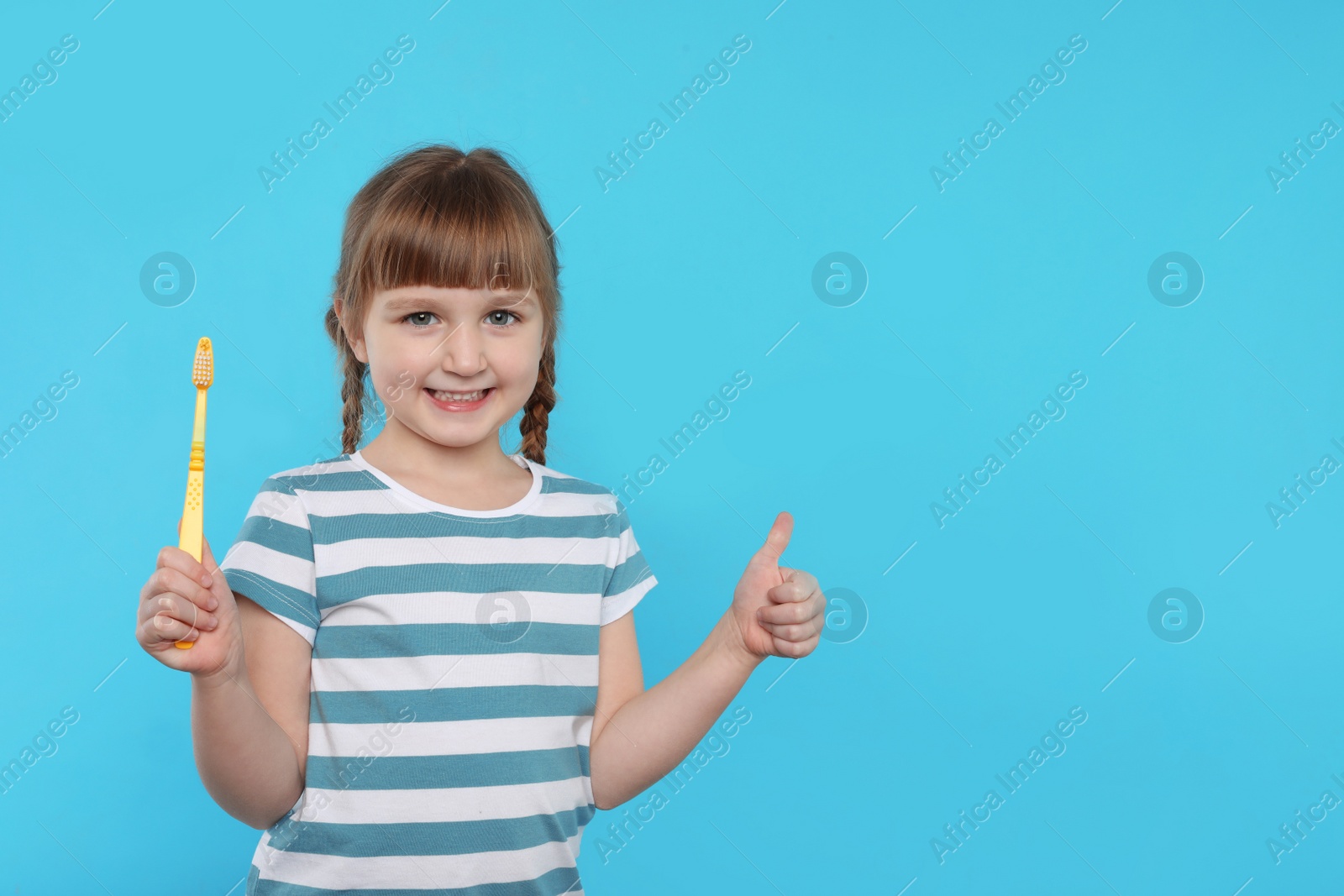 Photo of Little girl with toothbrush on color background. Teeth care