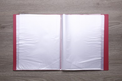 Photo of File folder with punched pockets on wooden table, top view