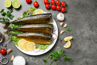 Photo of Flat lay composition with tasty smoked fish on grey table