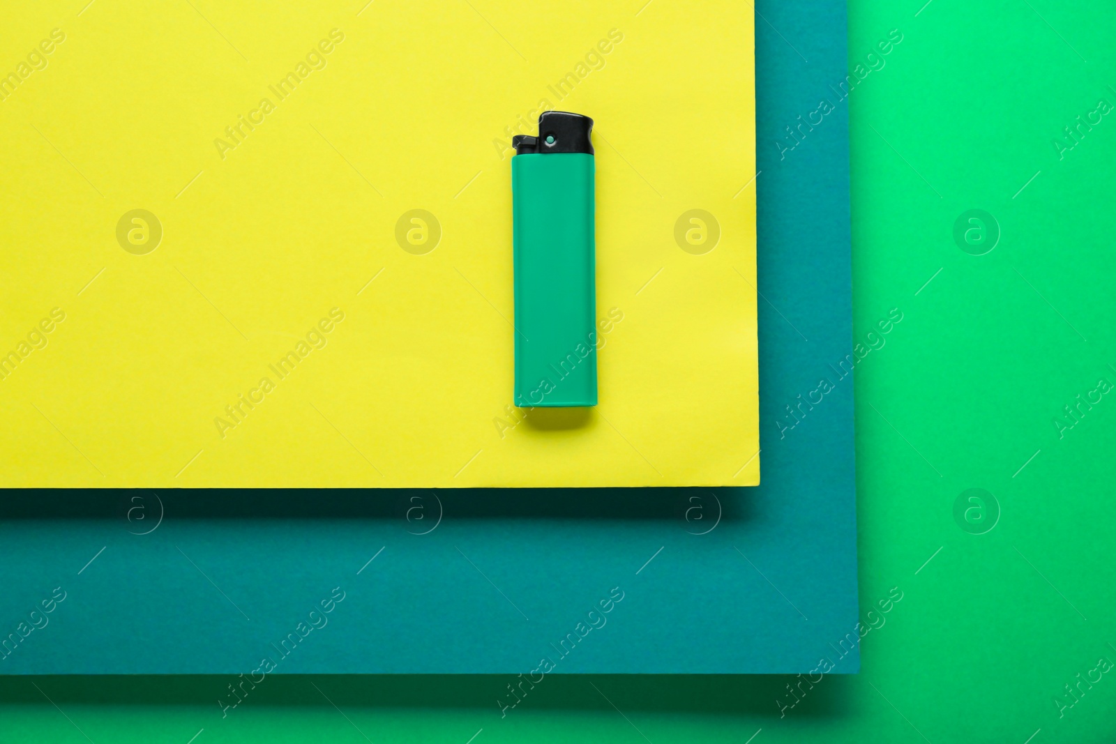 Photo of Stylish small pocket lighter on color background, top view