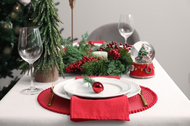 Luxury place setting with beautiful festive decor for Christmas dinner on white table