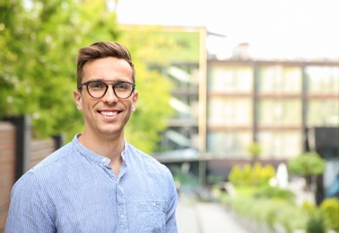 Photo of Portrait of attractive young man in stylish outfit outdoors