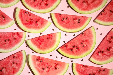 Photo of Watermelon slices on pink background, flat lay