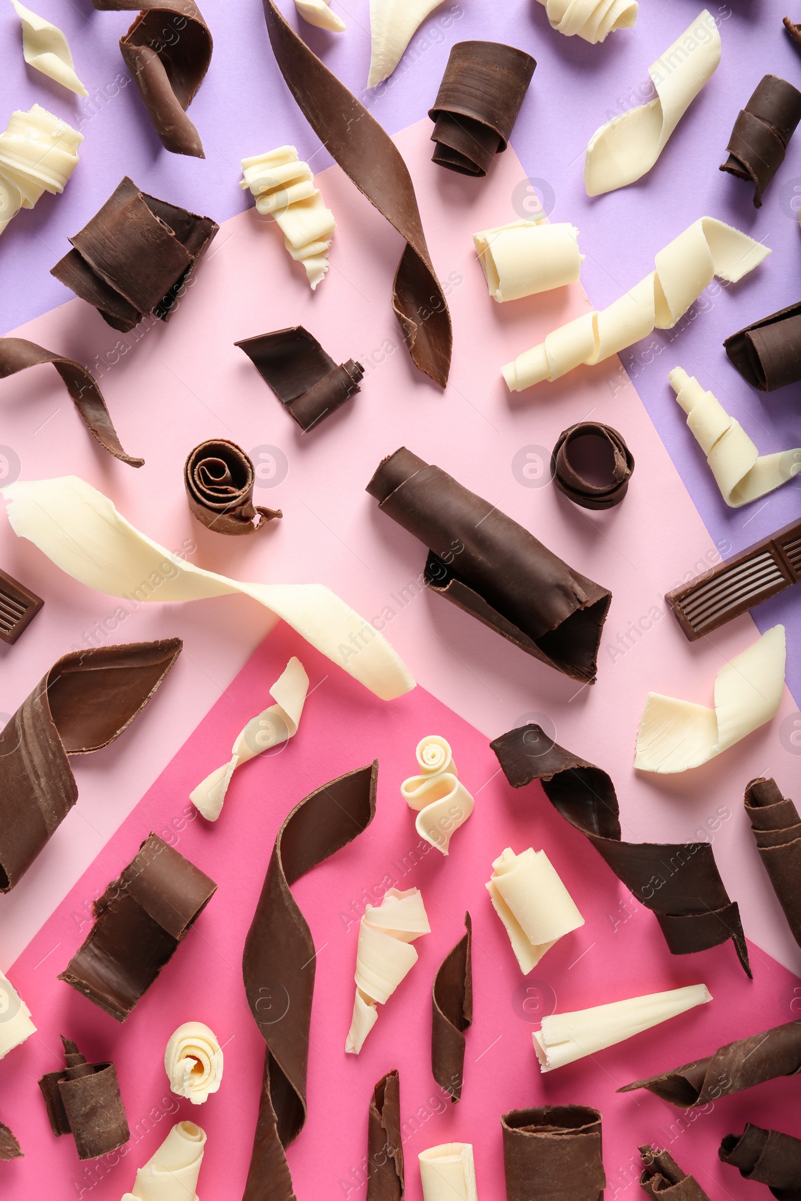 Photo of Yummy chocolate curls on color background, top view