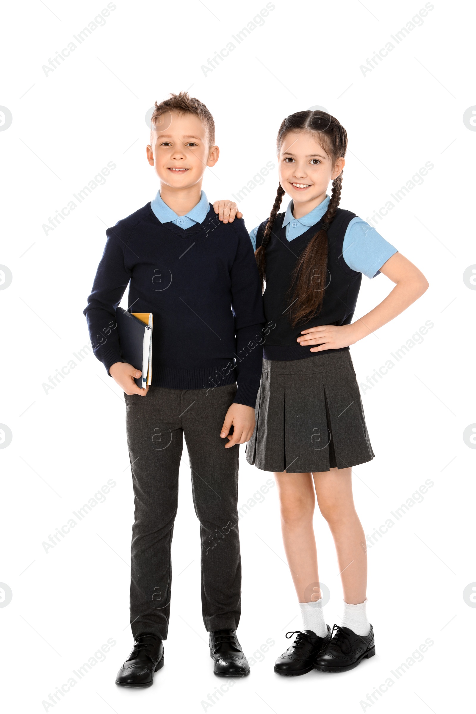 Photo of Full length portrait of cute children in school uniform on white background